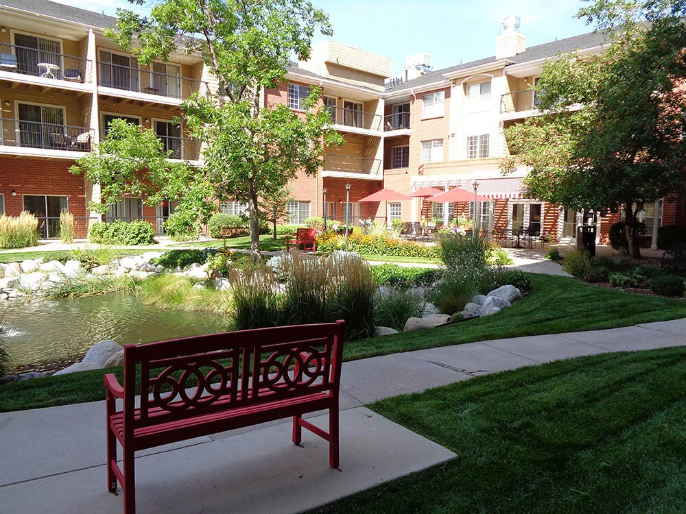 Outdoor garden area with a red bench