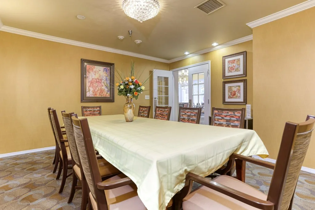 Dining room with a long table and floral centerpiece