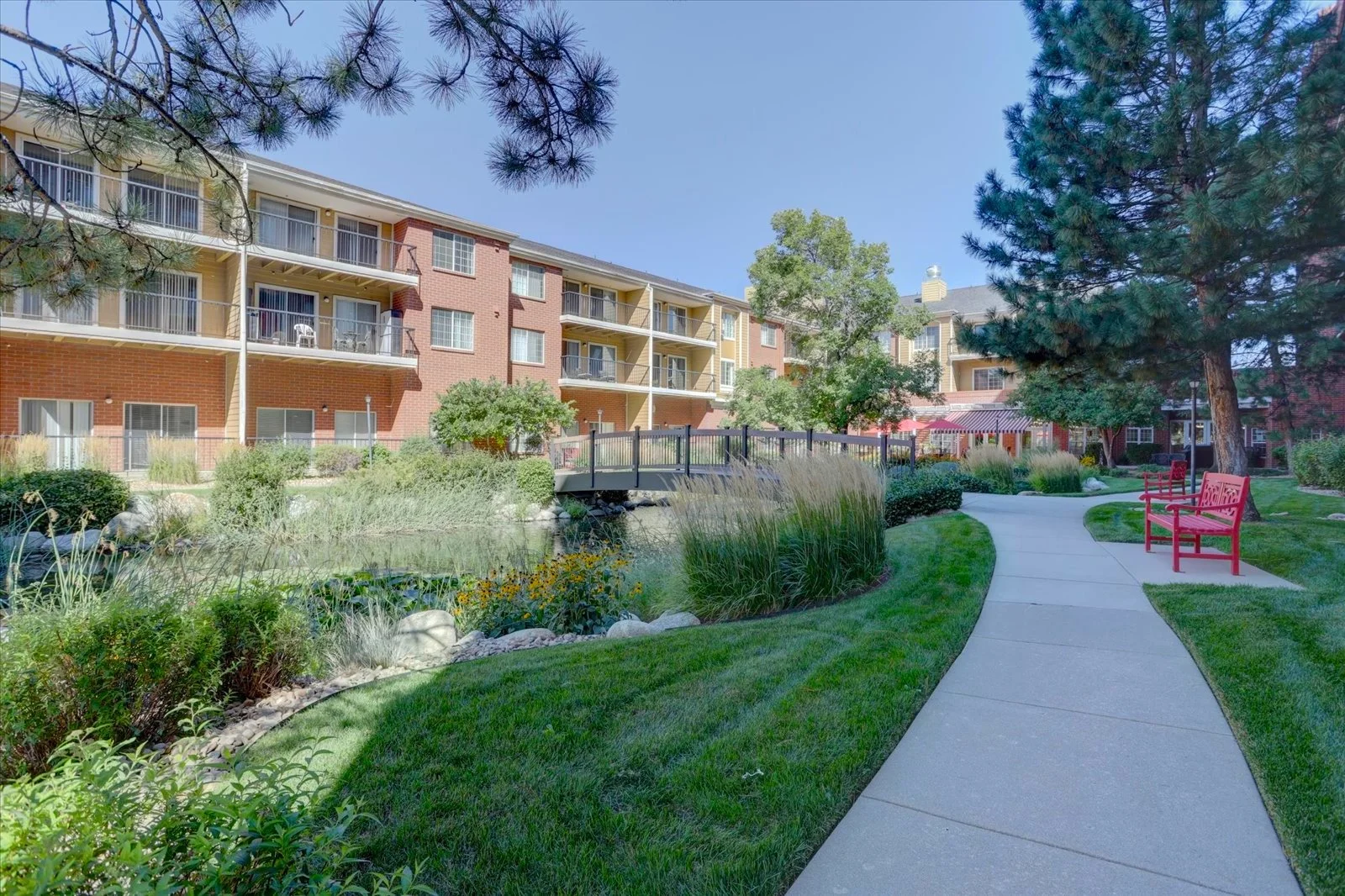 Pathway through landscaped outdoor area with seating