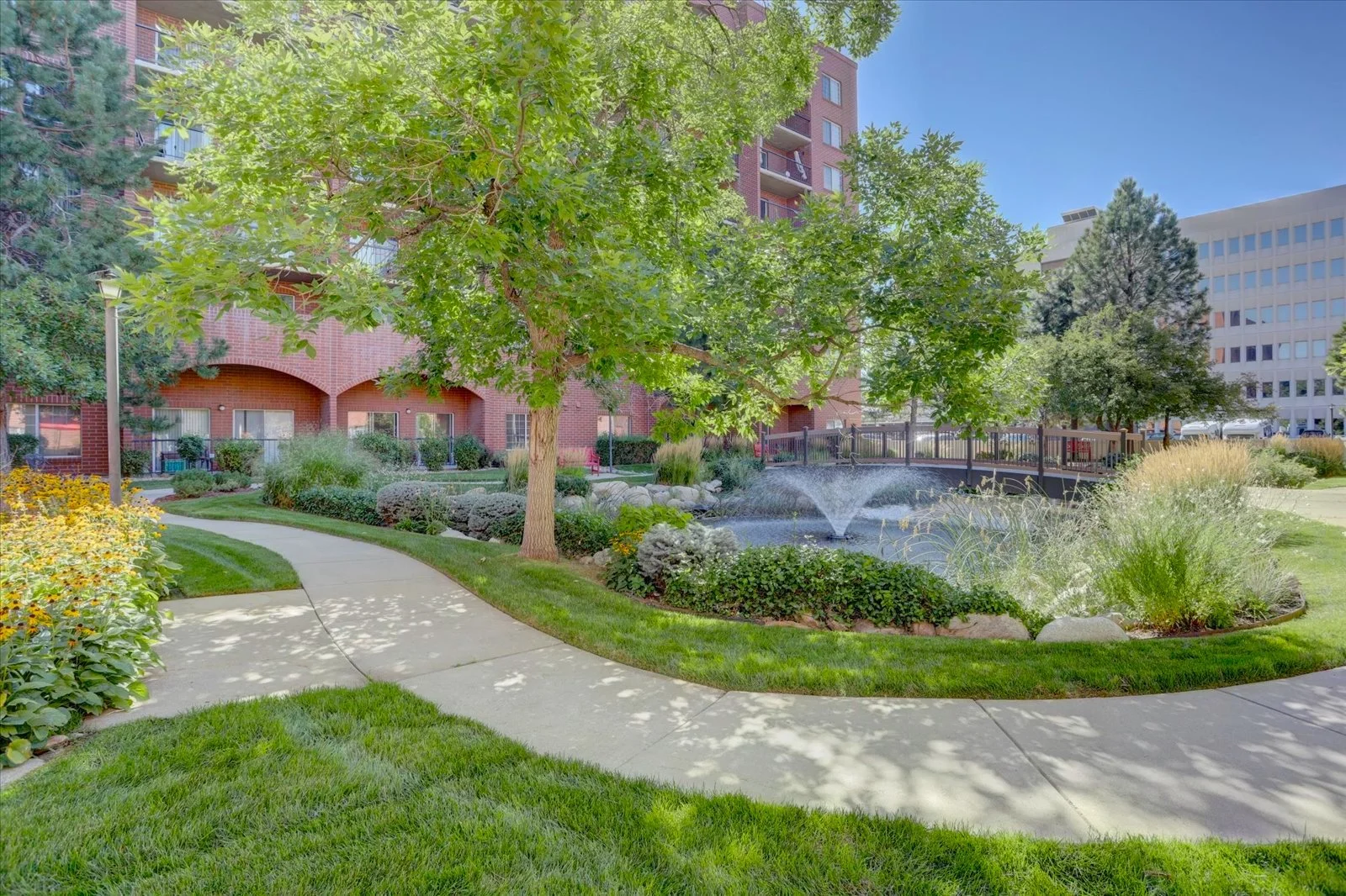 Serene outdoor space with a fountain and pathway.