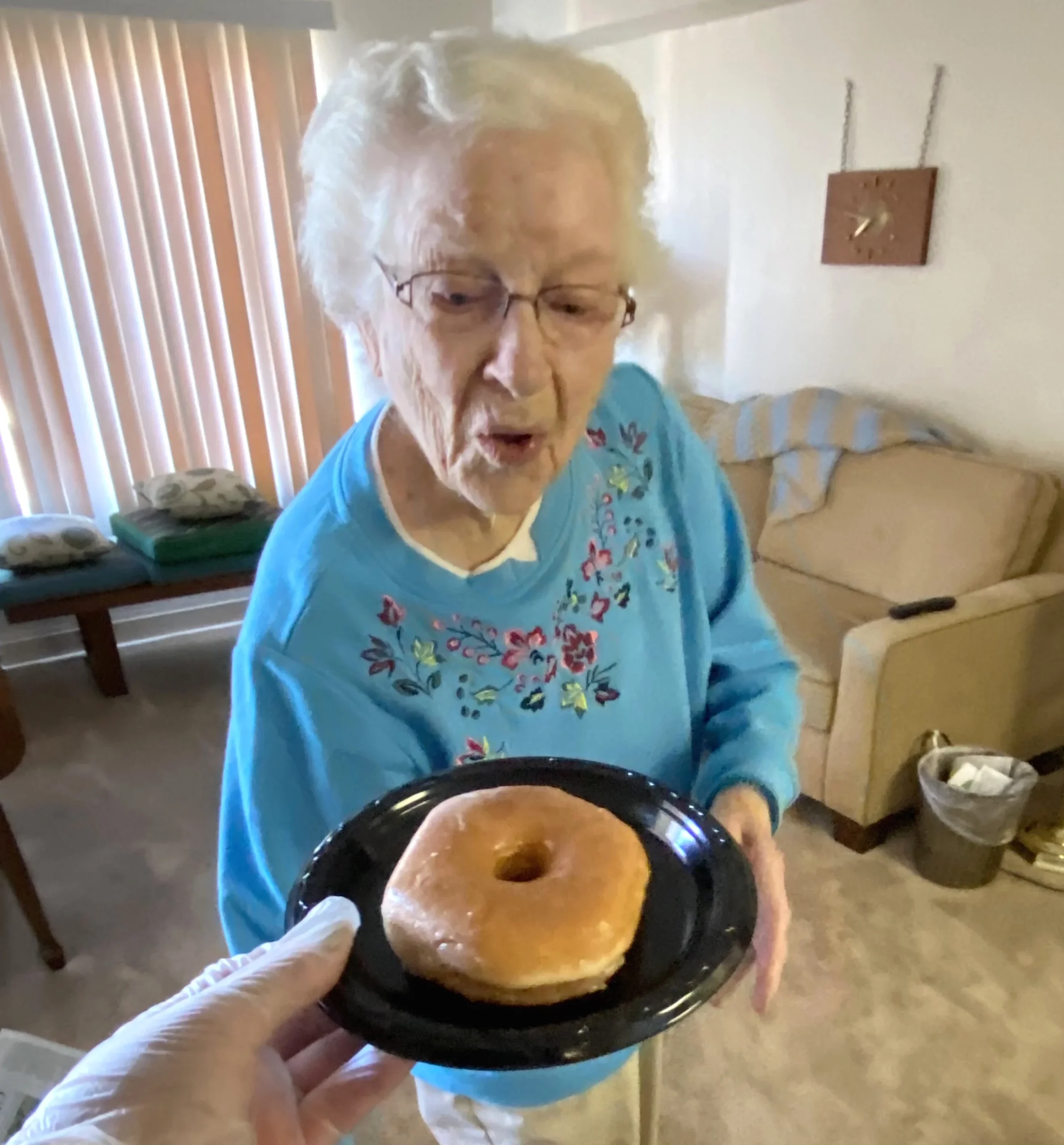 Elderly woman surprised by a donut