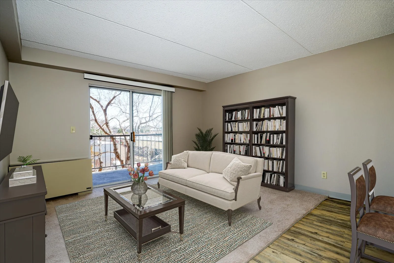 Bright living space with bookshelves and a balcony view.