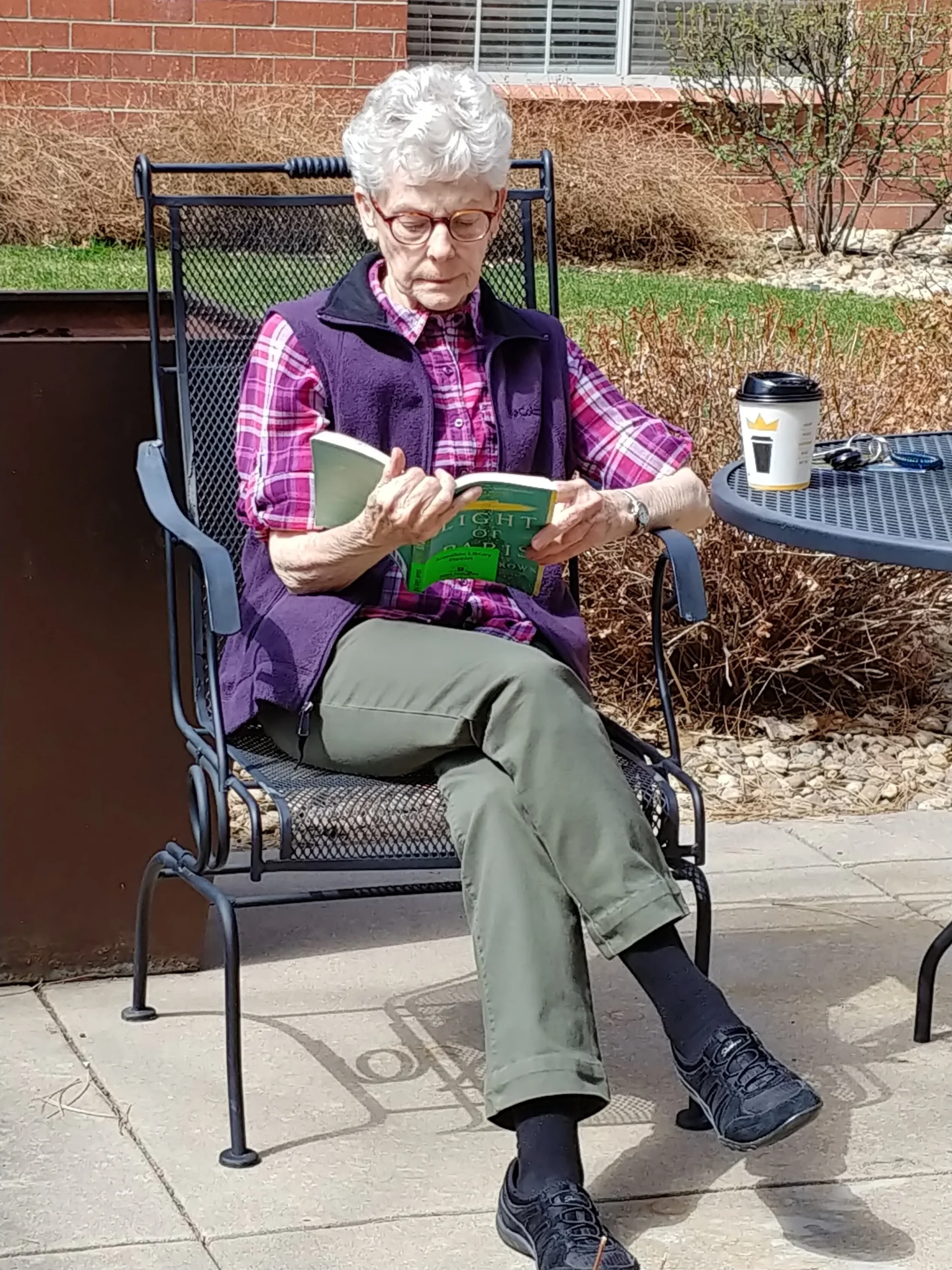 Senior woman reading in a garden chair