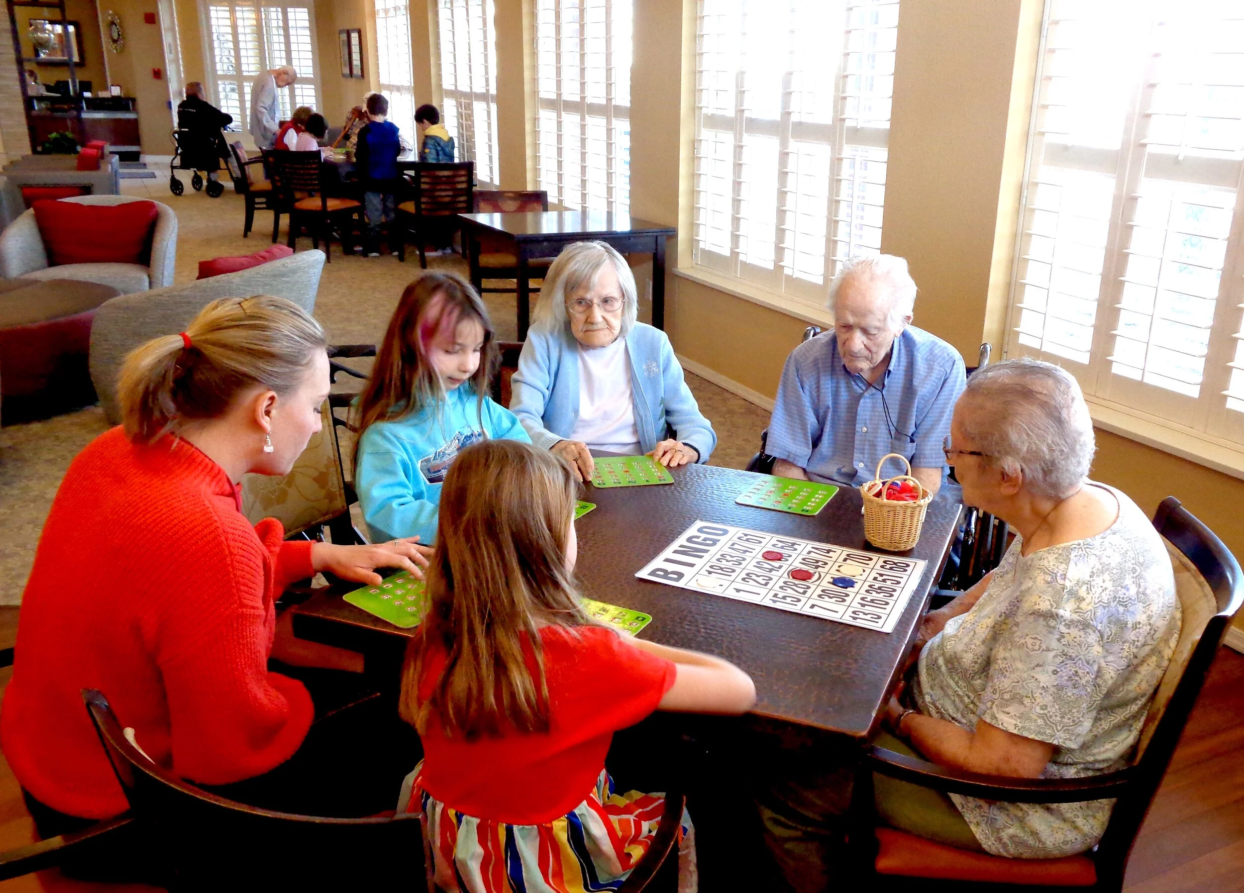 Residents and staff playing bingo together