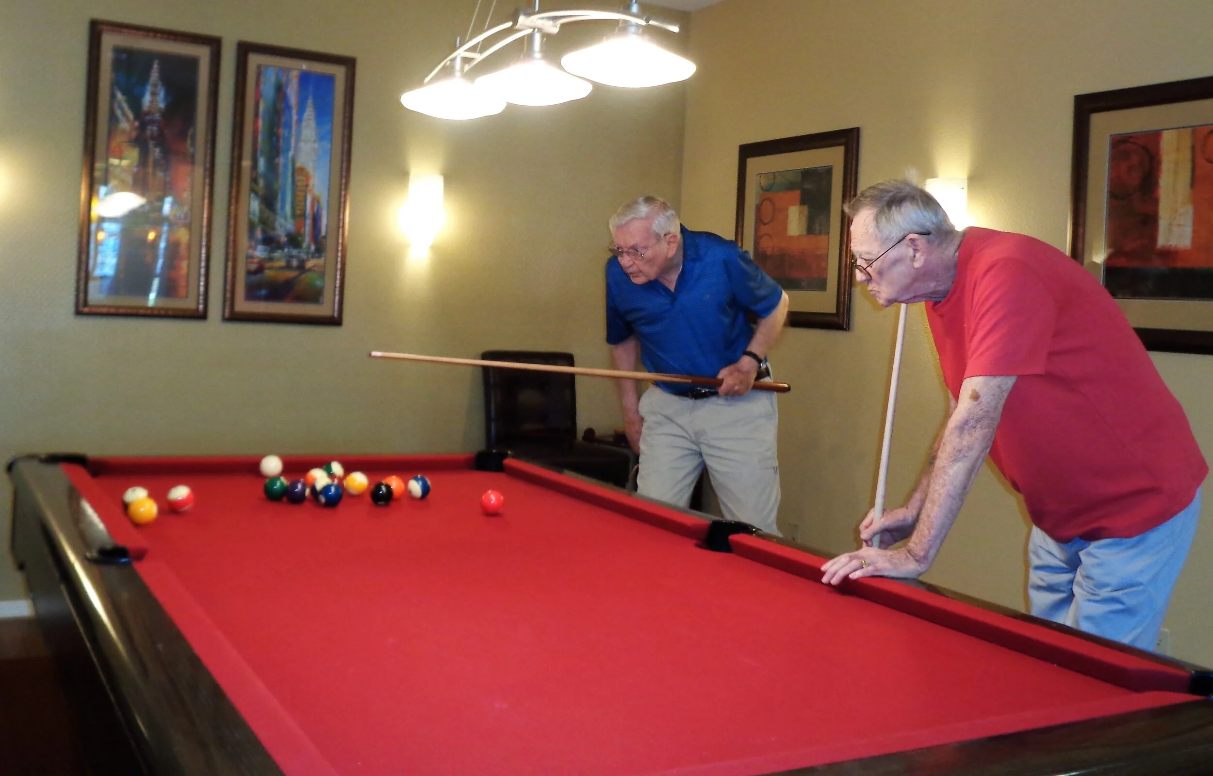 Residents enjoying a game of pool indoors.