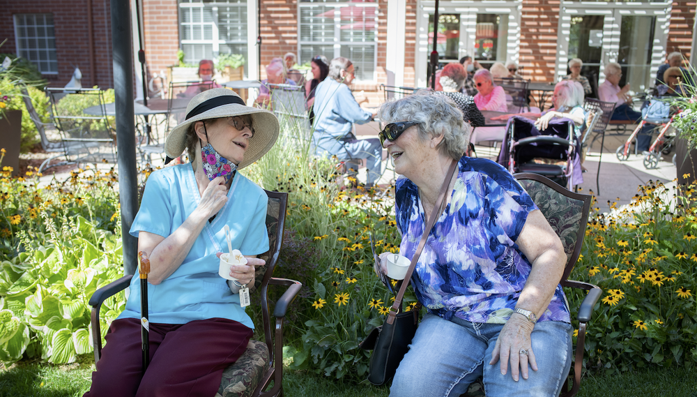 Two residents enjoying ice cream in the garden.