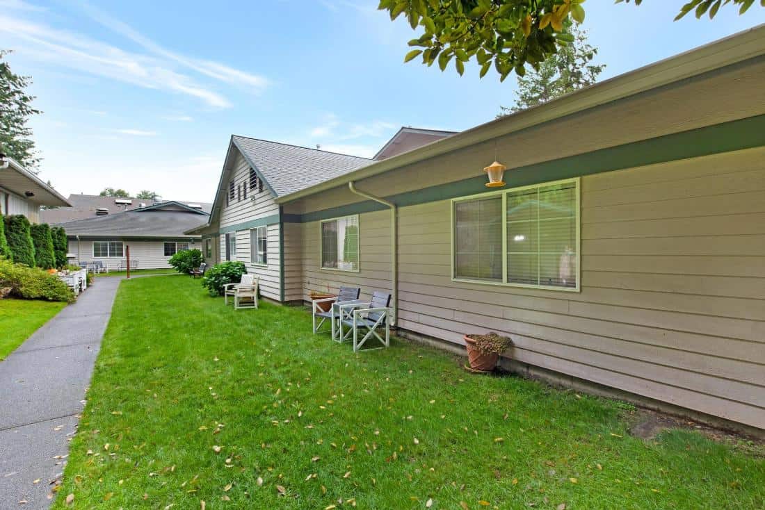 Well-maintained outdoor space with grassy area and seating.