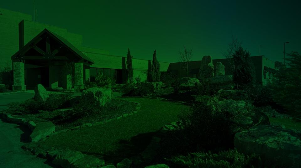 Entrance of Liberty Park Senior Living with landscaped outdoor space