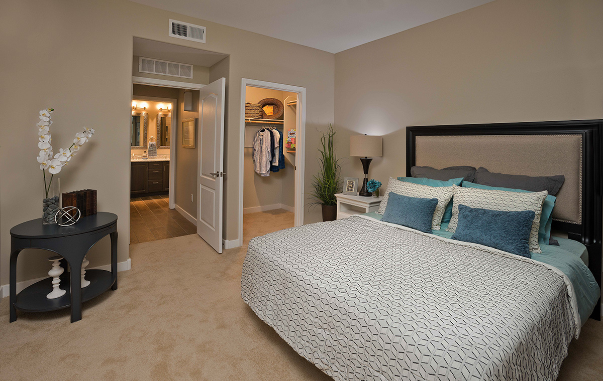 A well-furnished private bedroom in a senior living facility