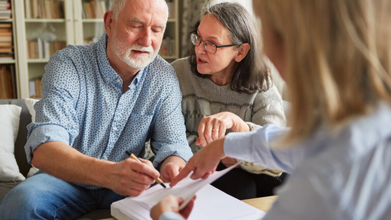 Residents receiving assistance with paperwork in a cozy setting