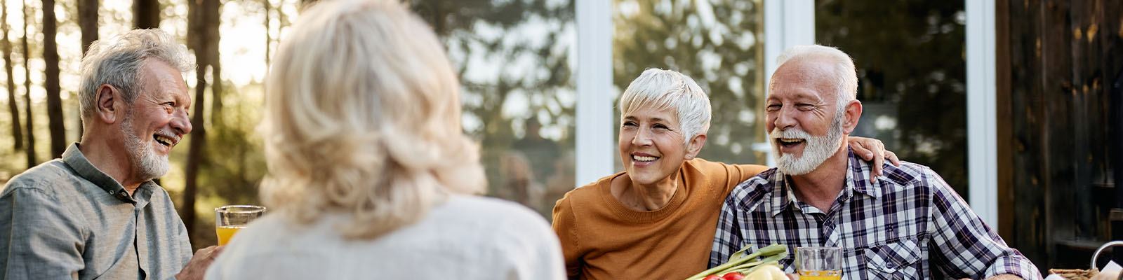 Seniors enjoying a cheerful outdoor gathering with drinks