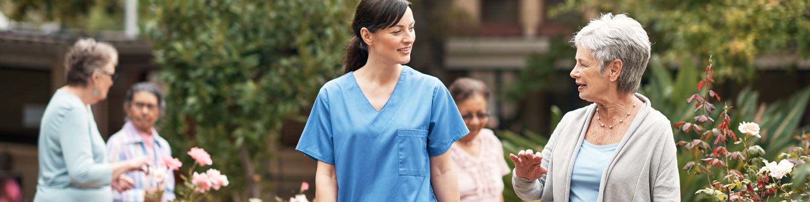 Staff and residents interacting in a garden
