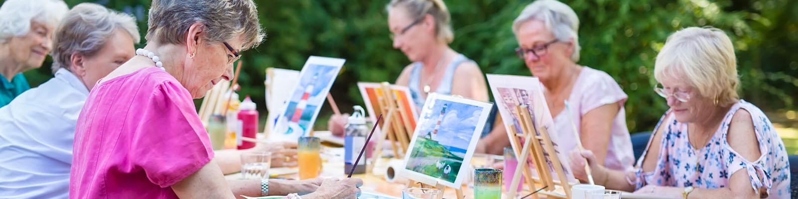 Residents participating in an outdoor painting activity