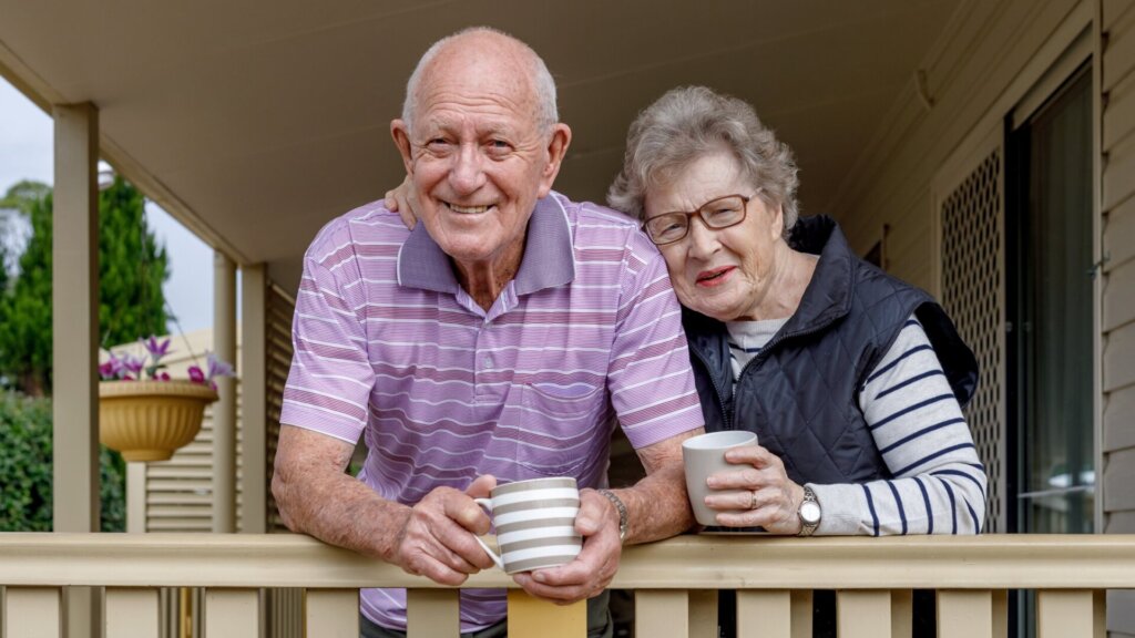Two happy residents enjoying coffee on a porch