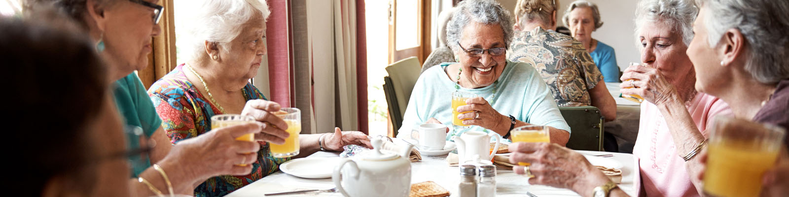 Residents enjoying drinks and each other's company at a table