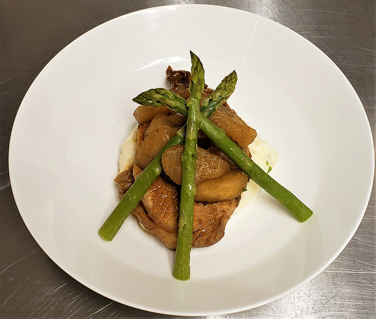 Beautifully plated meal with asparagus and apples