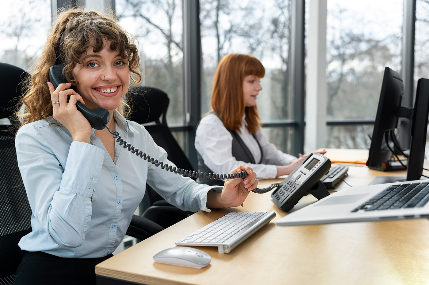 Receptionist answering phone calls in an office setting