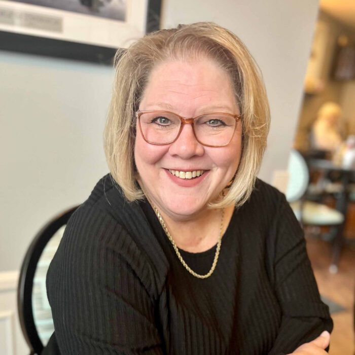 Resident smiling in a cozy common area