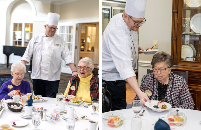 Residents enjoying a meal with staff in a dining area