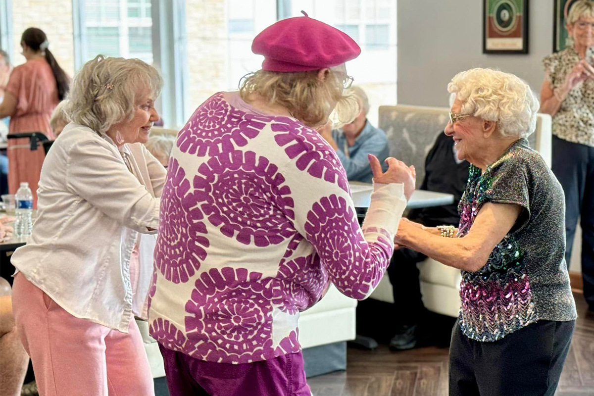 Residents dancing in a lively activity room