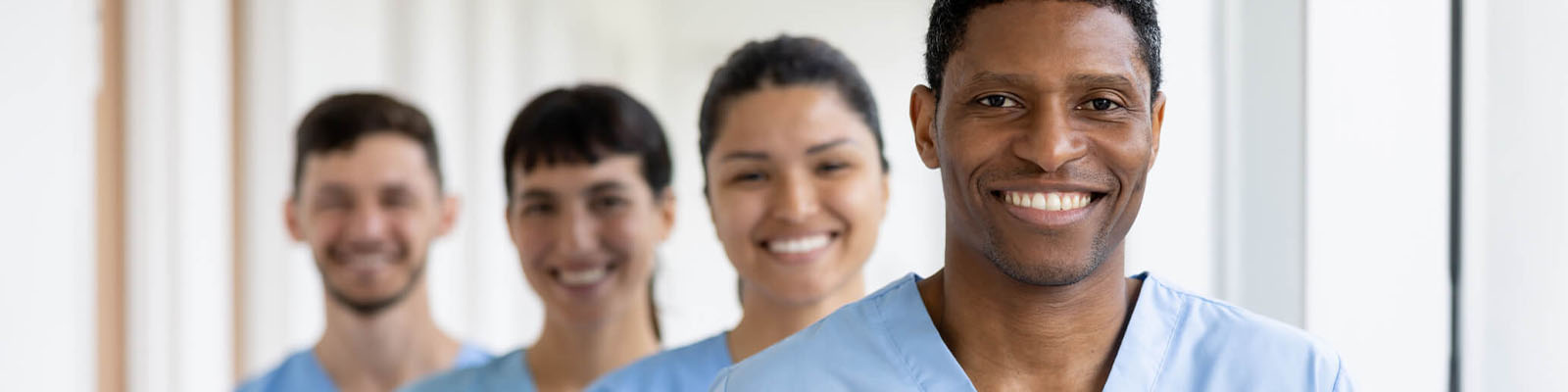Staff members smiling in a bright corridor