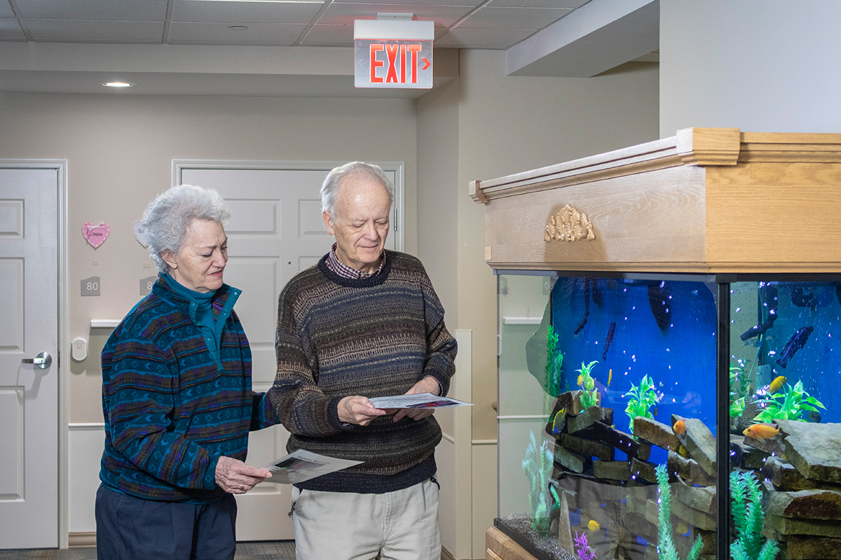 Residents enjoying a moment by an aquarium