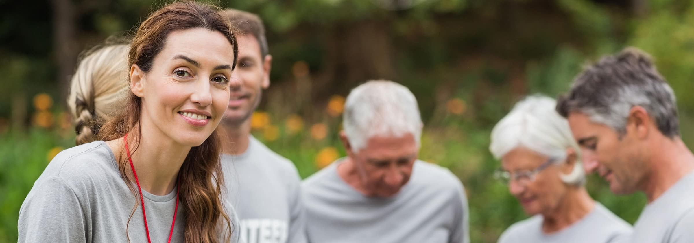 Group of volunteers engaging with seniors in a garden