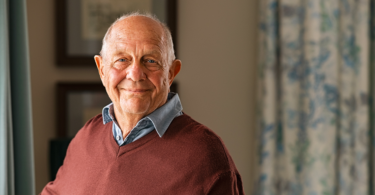 Smiling elderly man in a cozy indoor setting