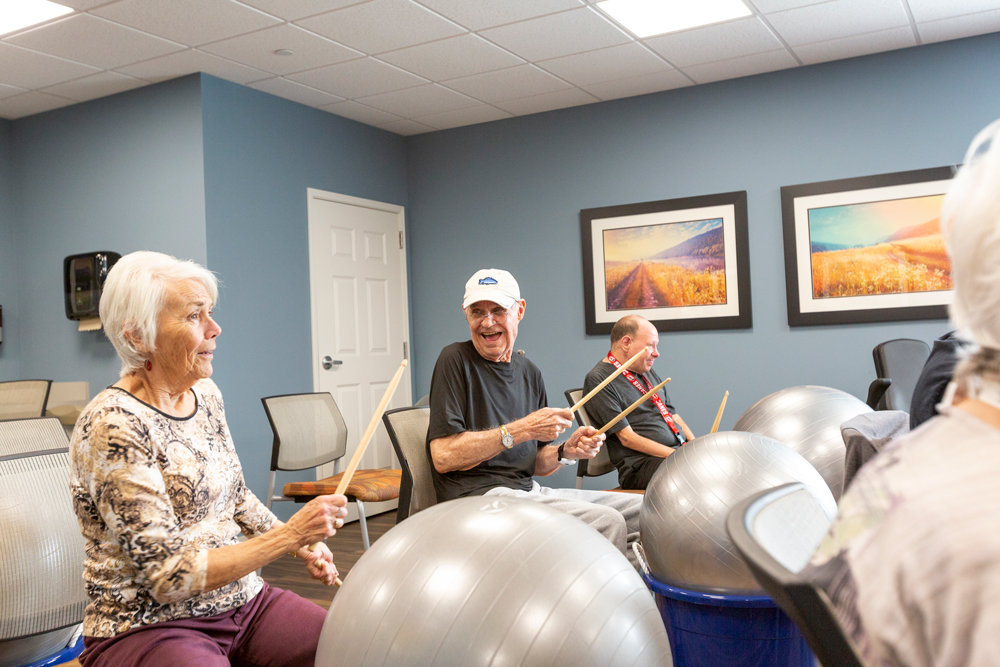 Residents participating in a music activity with exercise balls