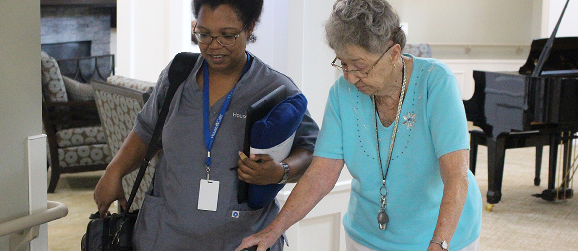 Staff assisting a resident in a common area