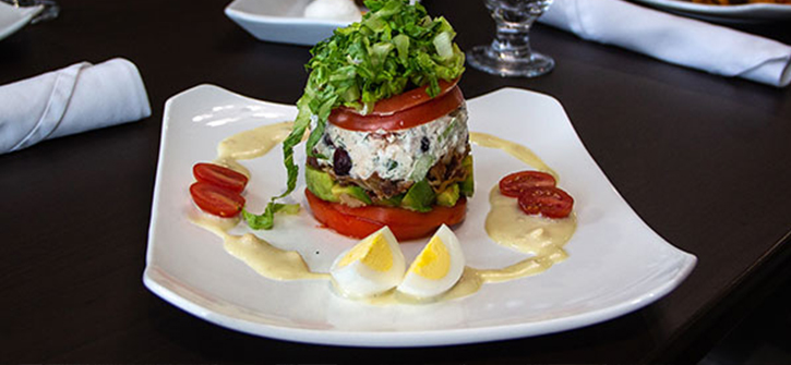 A colorful gourmet food dish with salad and eggs