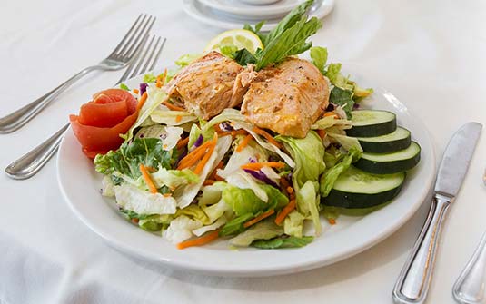 A fresh salmon salad with vegetables on a plate