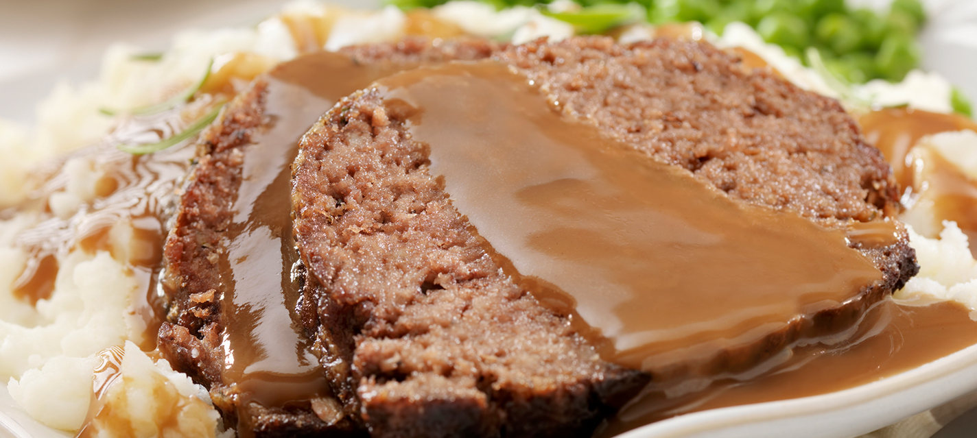 Close-up of meatloaf with gravy and mashed potatoes