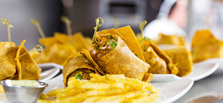 Plated food with wraps and fries
