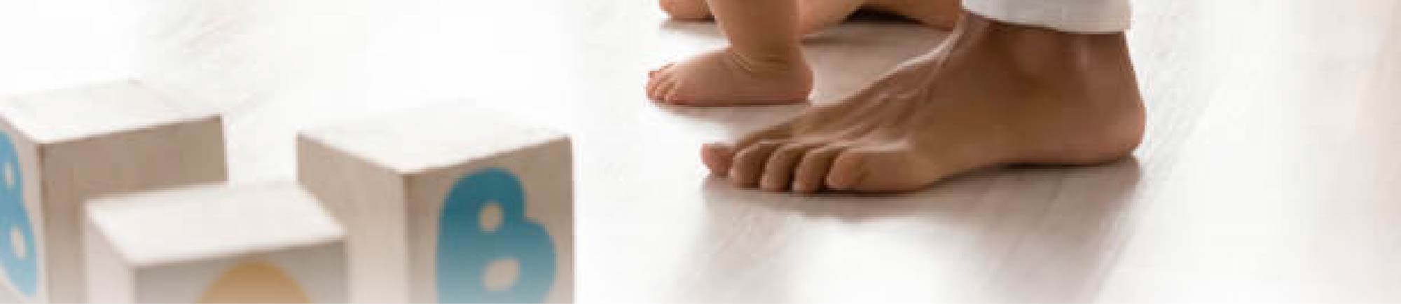 Close-up of feet and blocks on a floor