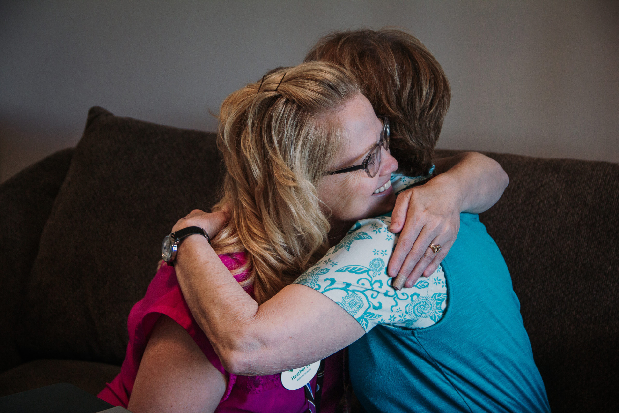 Two residents hugging in a cozy living room