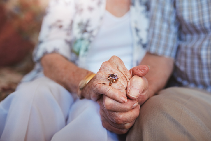 Close-up of two residents holding hands