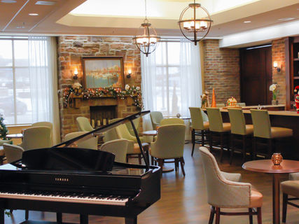 Interior view of a cozy common area with a piano