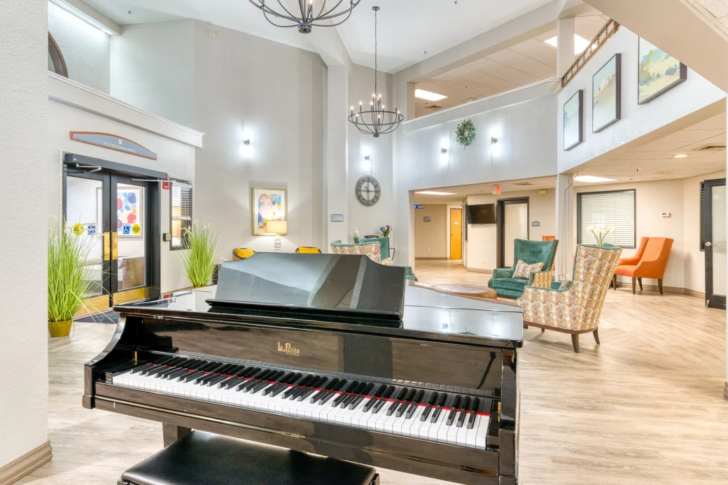 Bright lobby area with a piano and seating