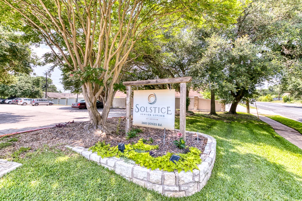 Facility sign in a landscaped outdoor area