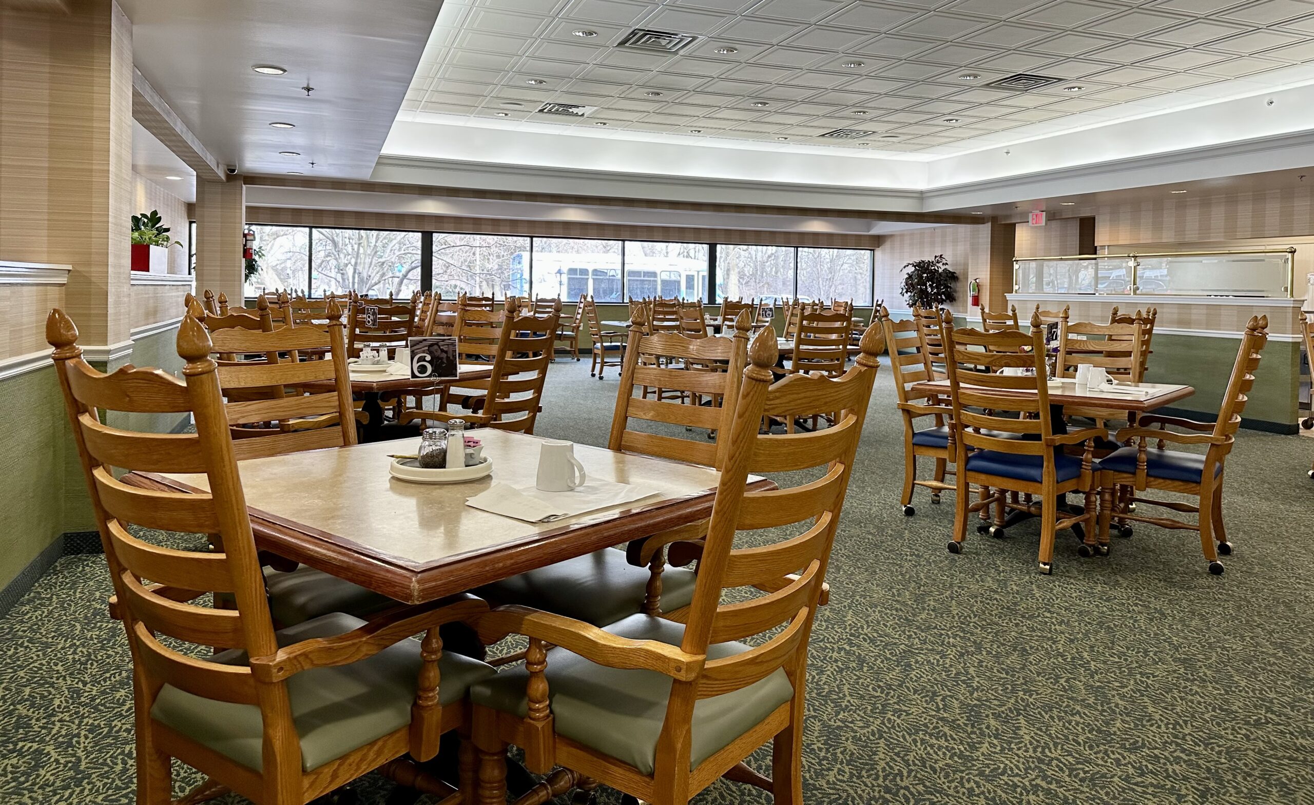 Bright and spacious dining room with wooden tables