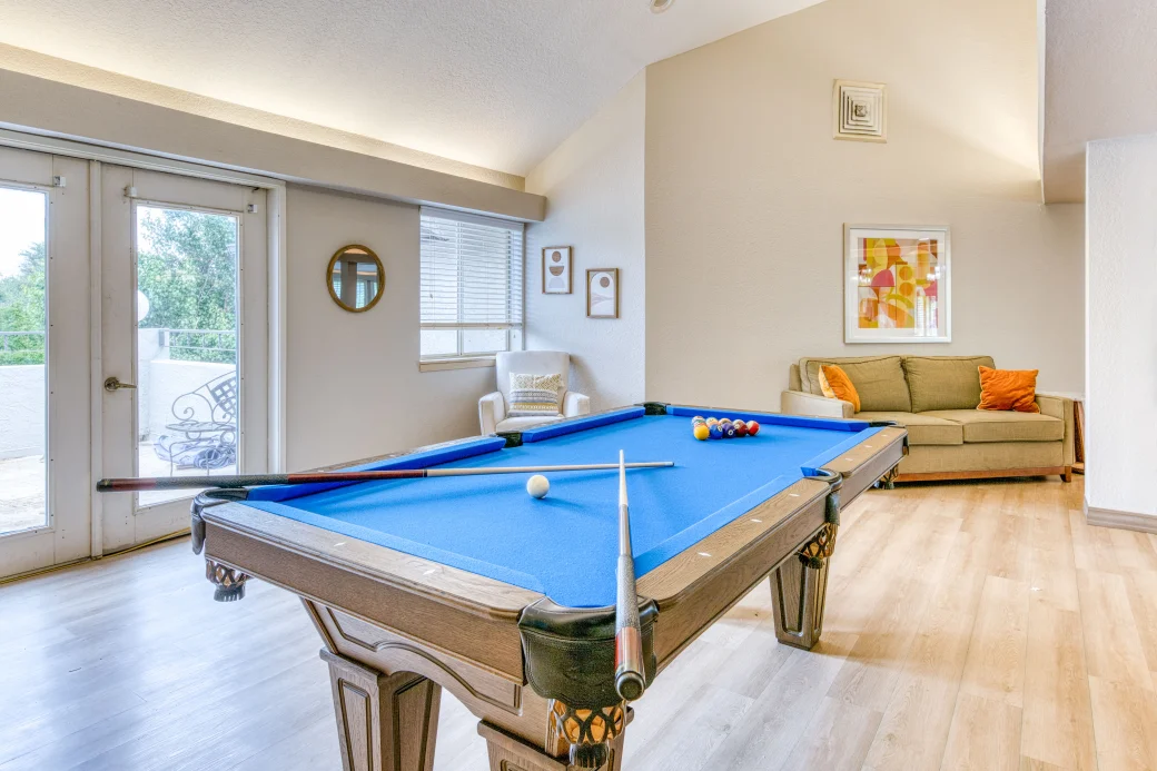 Bright common area with a pool table and seating