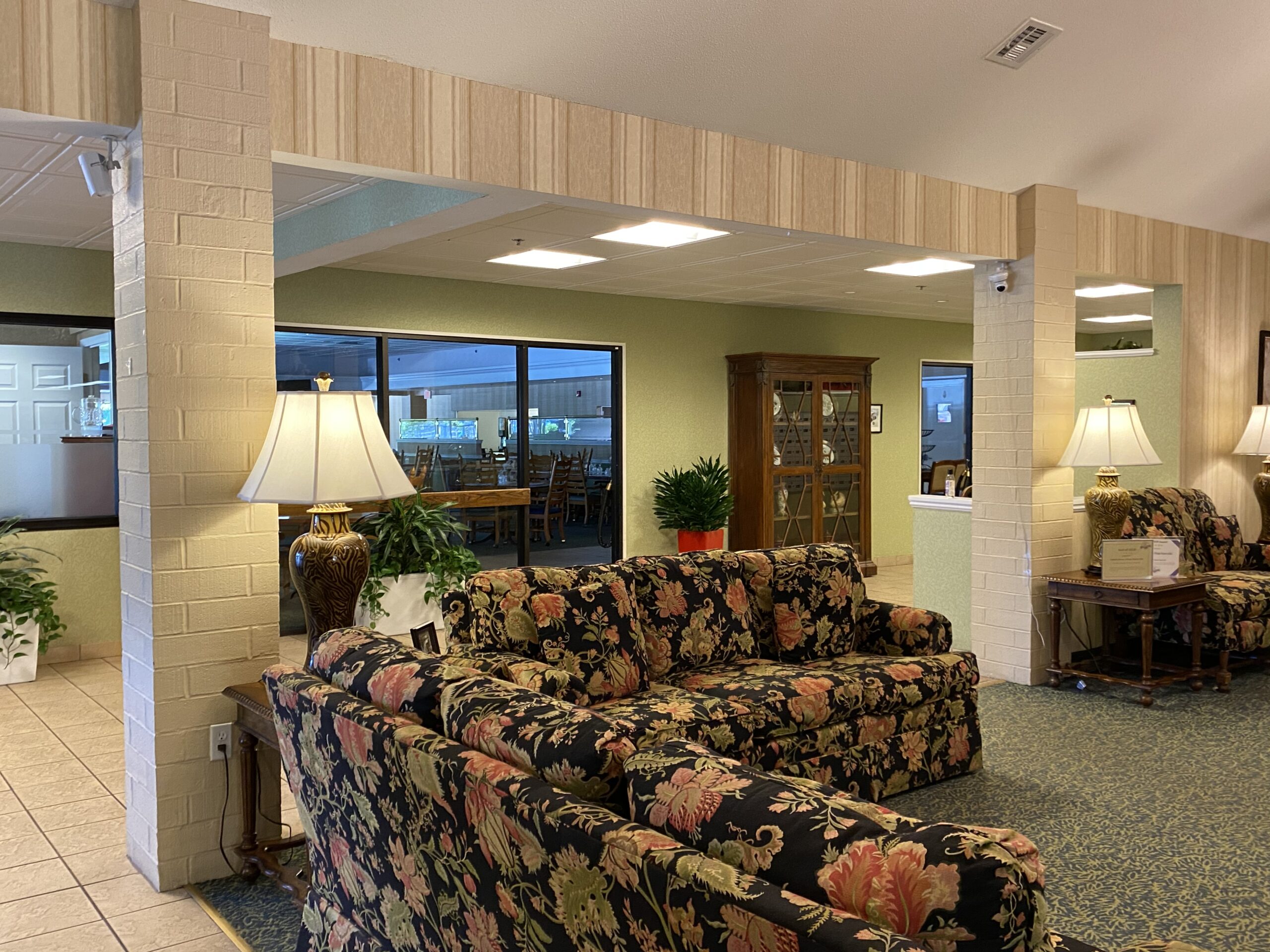 Cozy interior with floral seating and lamps