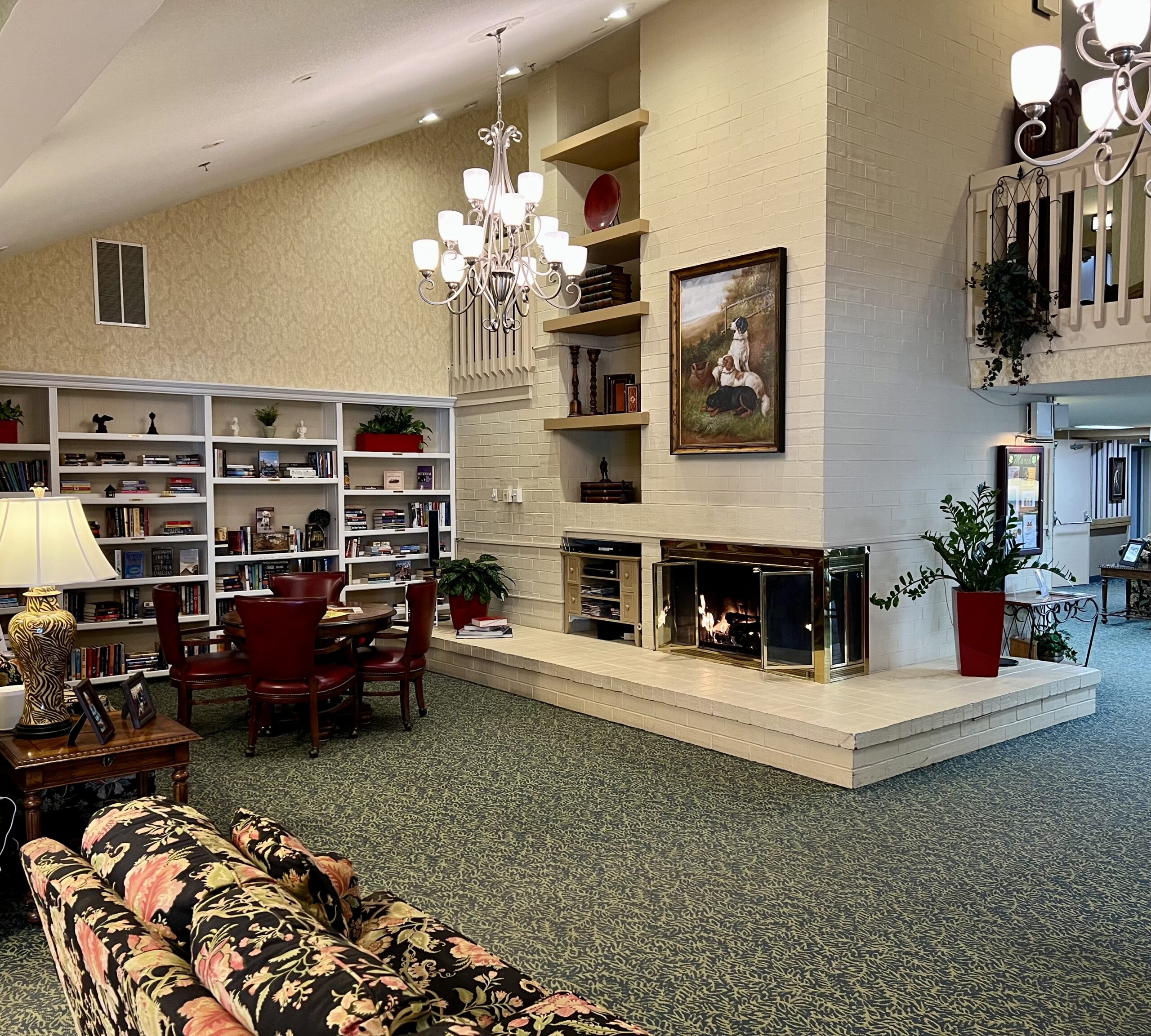 Cozy common area with bookshelves and a fireplace