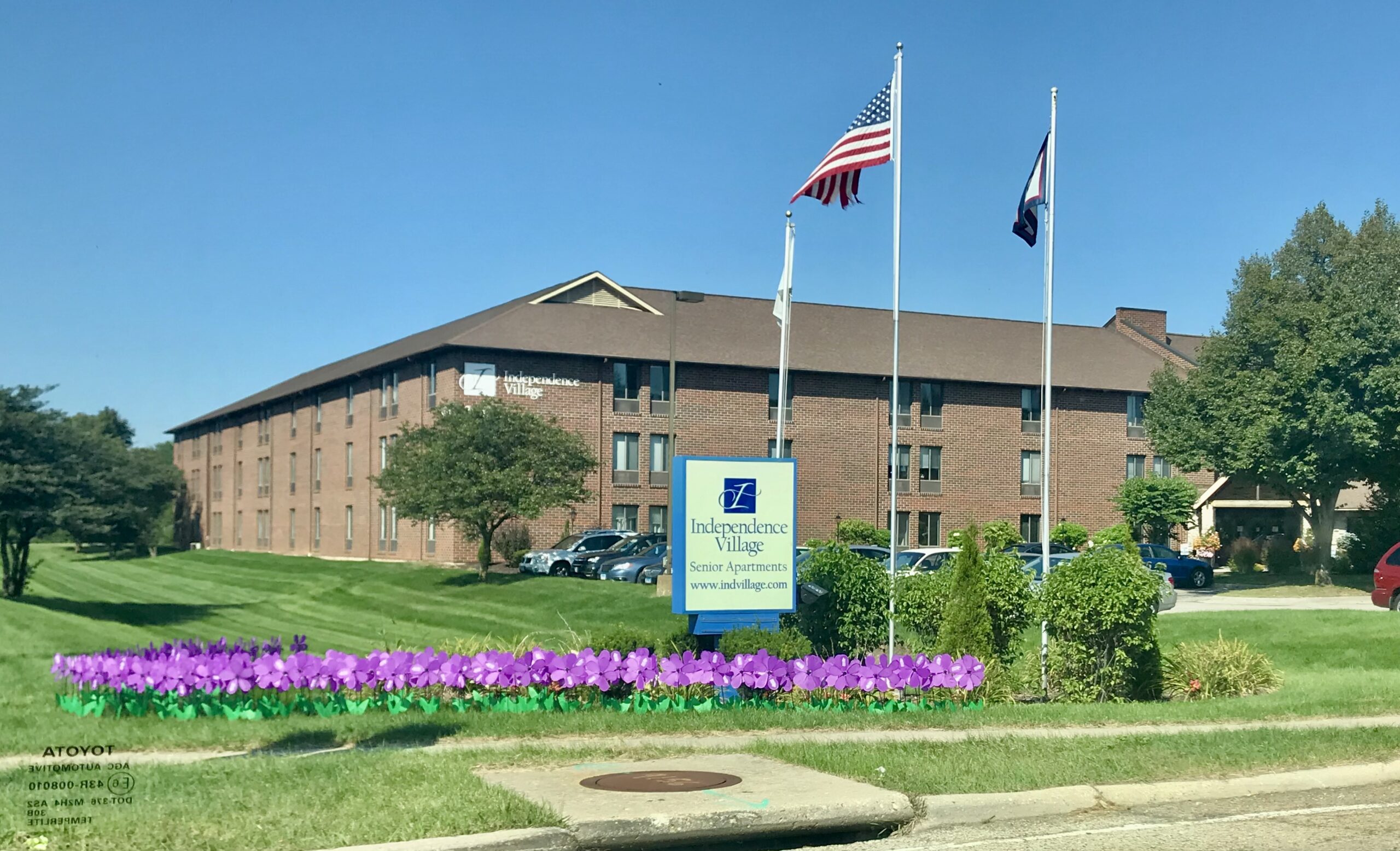 Exterior view of Independence Village with landscaped entrance