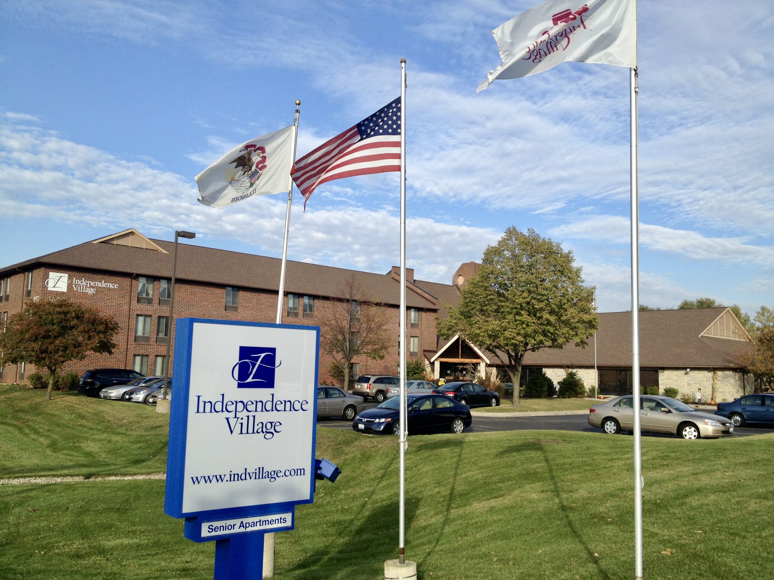 Exterior view of Independence Village with flags and signage