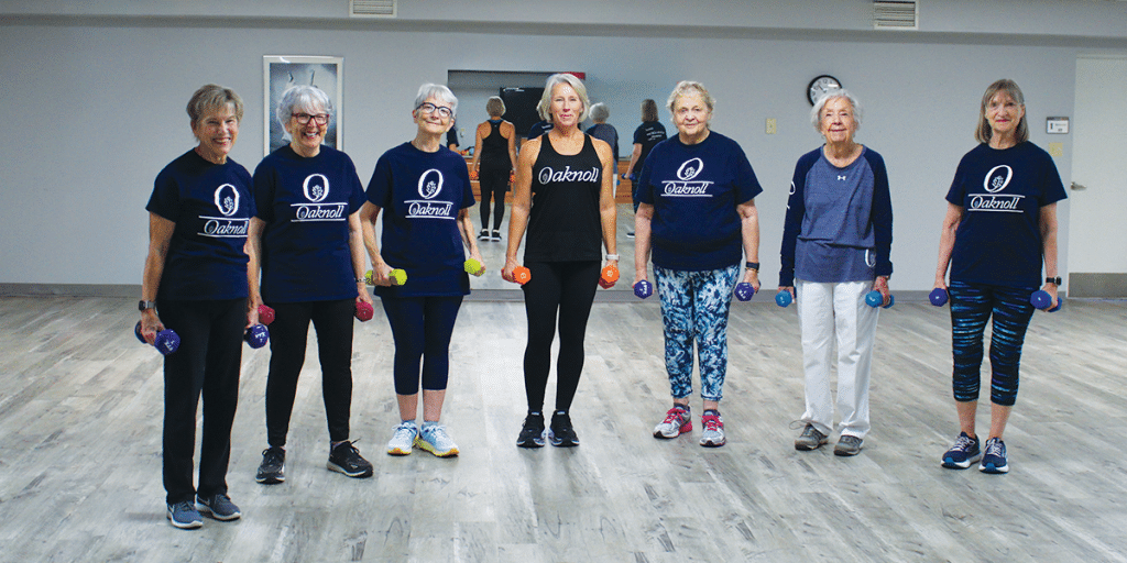 Residents participating in a fitness class with weights
