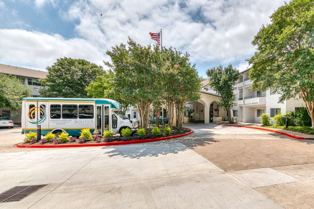 Transport van outside the entrance of a senior living facility