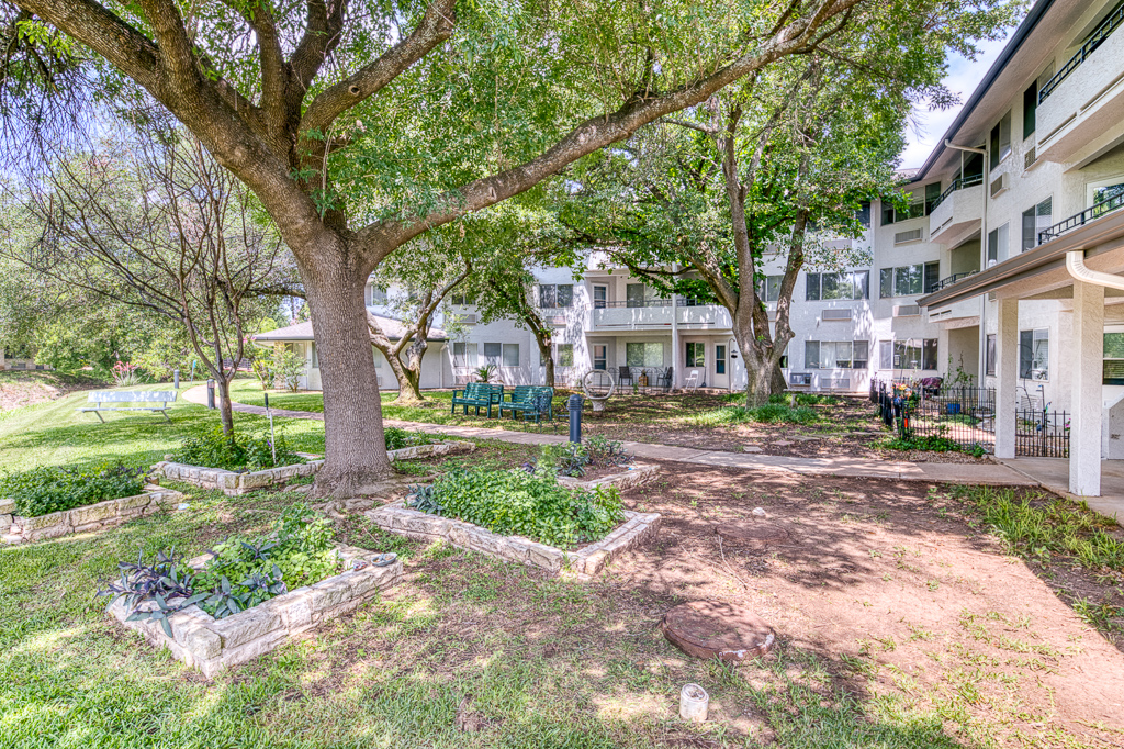 Outdoor space with seating and gardens near the building