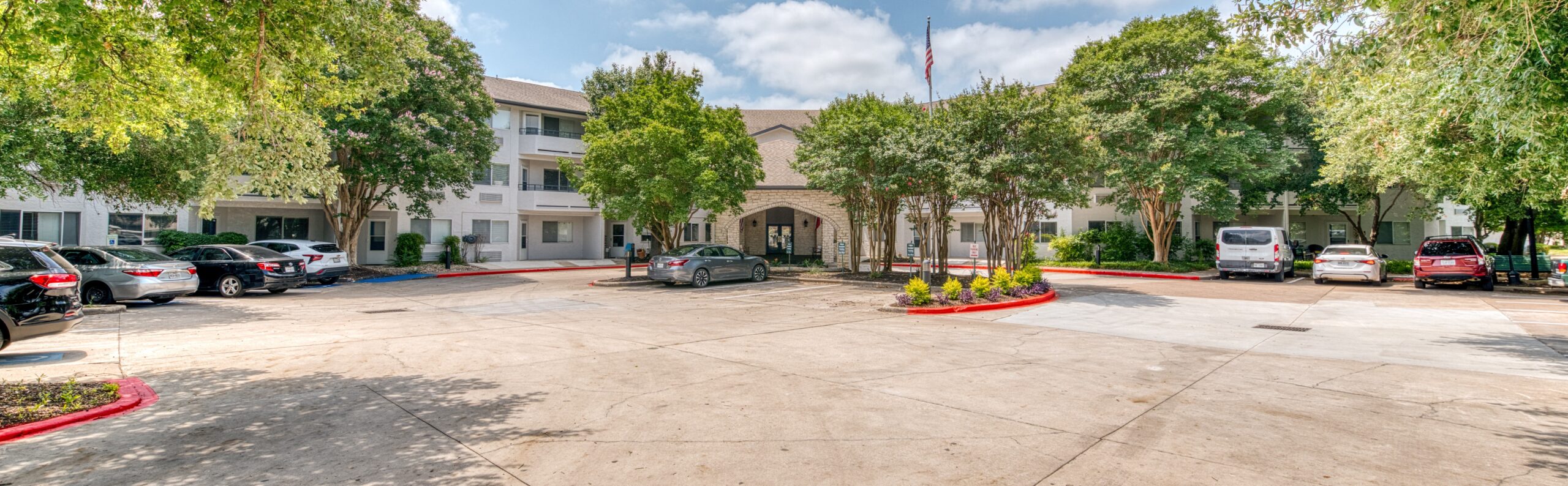 Exterior view of Solstice Senior Living at Austin with parking area